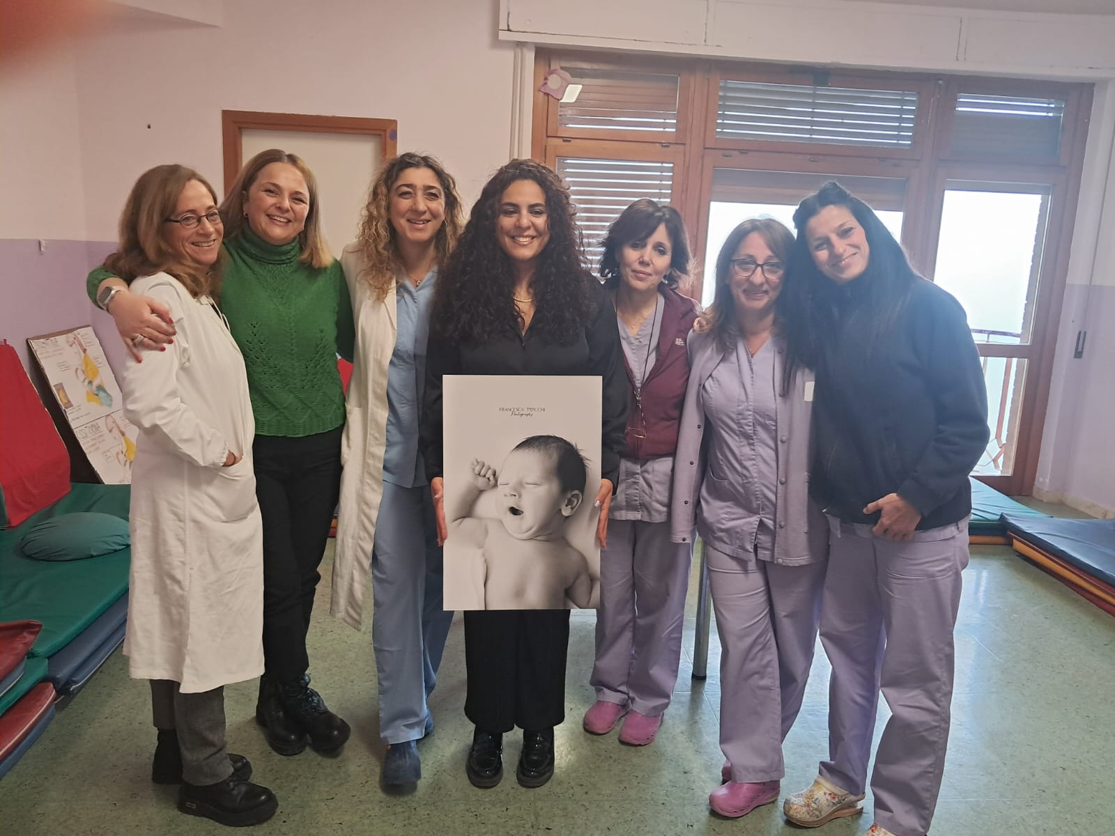 img title La fotografa Francesca Tocchi con il personale sanitario del Centro Donna di Assisi durante la donazione di stampe fotografiche.